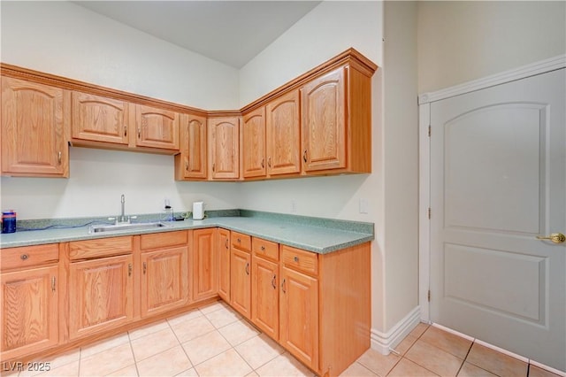 kitchen featuring light tile patterned floors and sink