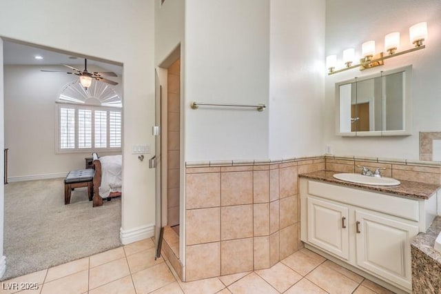 bathroom with ceiling fan, tile patterned flooring, and vanity