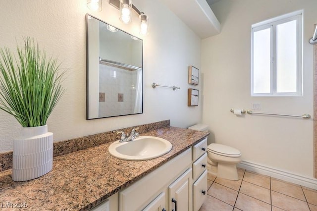 bathroom featuring a shower, tile patterned floors, vanity, and toilet