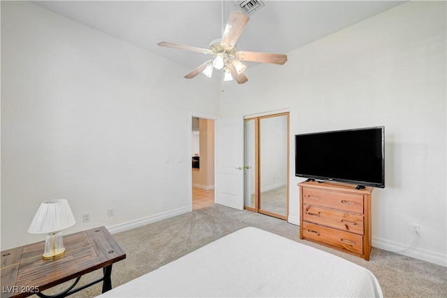 carpeted bedroom featuring ceiling fan, a closet, and high vaulted ceiling