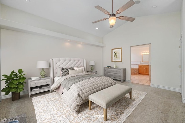 bedroom featuring ceiling fan, ensuite bath, lofted ceiling, and light carpet