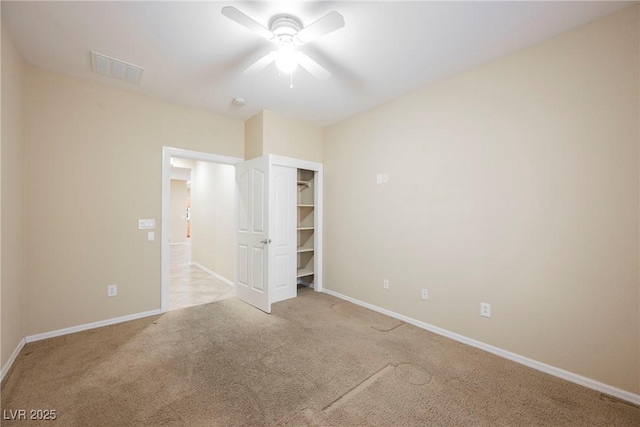 unfurnished bedroom featuring light carpet, ceiling fan, and a closet