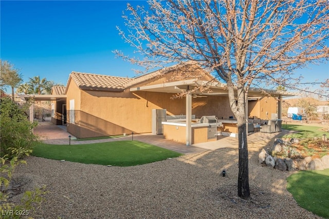 back of property featuring a patio and area for grilling