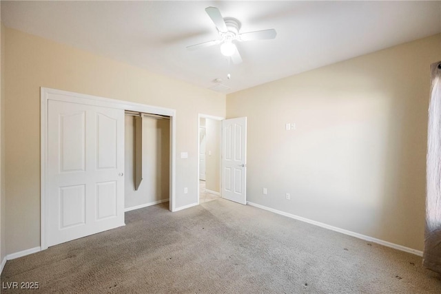 unfurnished bedroom featuring ceiling fan, a closet, and light carpet