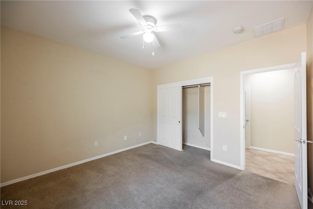 unfurnished bedroom featuring light carpet, a closet, and ceiling fan