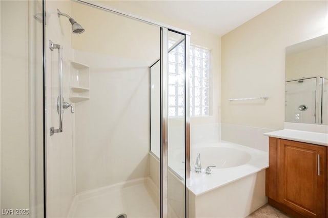 bathroom with vanity and independent shower and bath