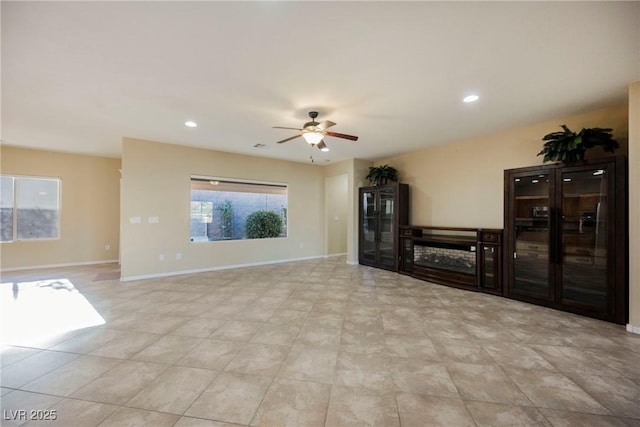 unfurnished living room featuring ceiling fan