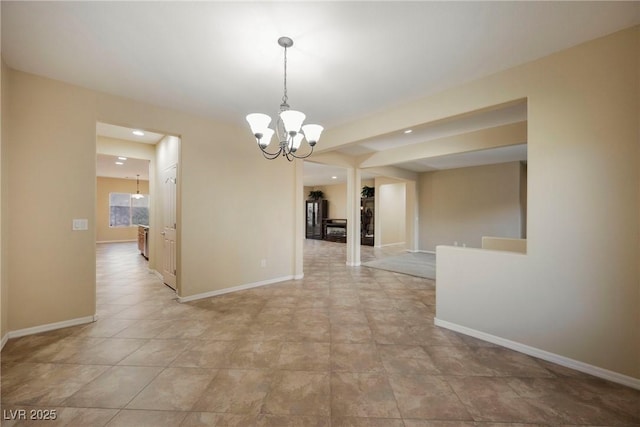 unfurnished dining area featuring a chandelier