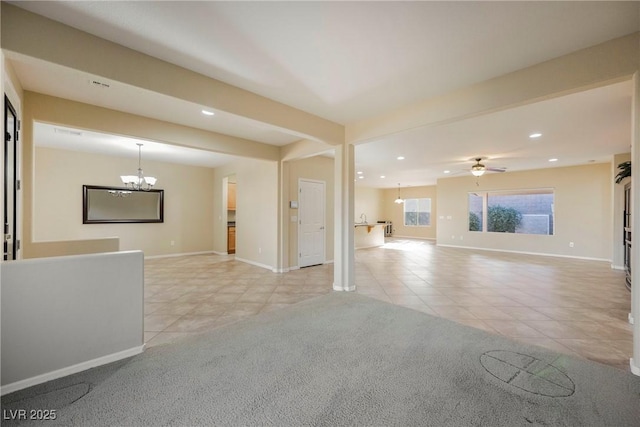 unfurnished living room with light tile patterned floors and ceiling fan with notable chandelier