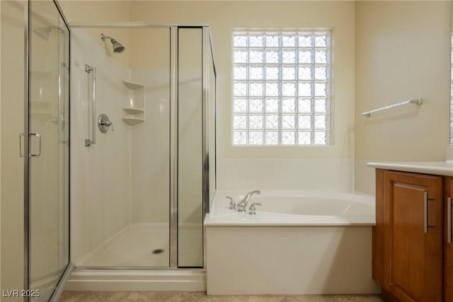 bathroom with shower with separate bathtub and vanity