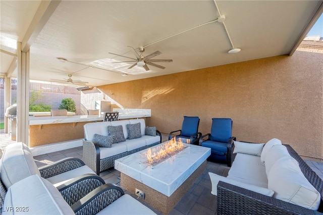 view of patio / terrace featuring an outdoor living space with a fire pit and ceiling fan