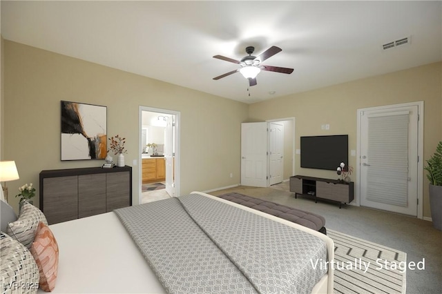 bedroom featuring light carpet, ensuite bath, a closet, and ceiling fan