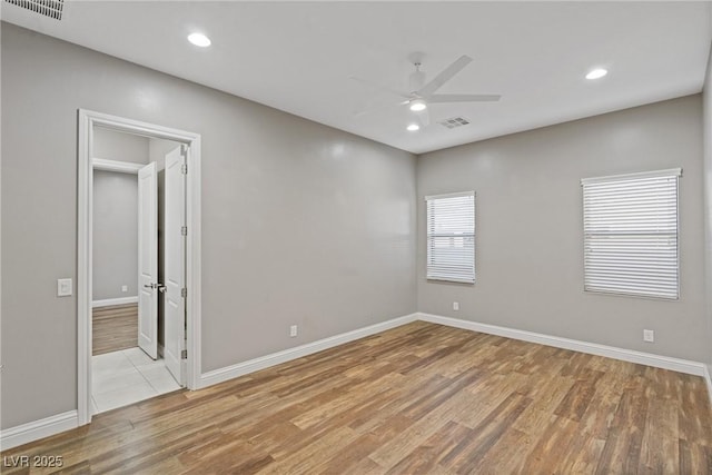 unfurnished room featuring ceiling fan and light hardwood / wood-style flooring