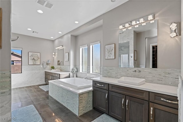 bathroom featuring vanity, tile patterned flooring, and plus walk in shower