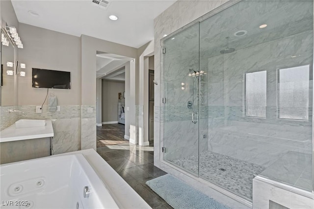 bathroom with vanity and independent shower and bath