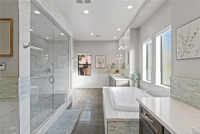 bathroom featuring separate shower and tub and vanity