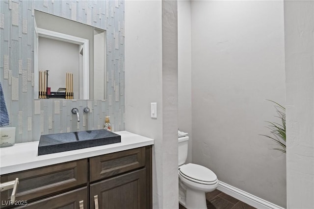 bathroom with toilet and vanity