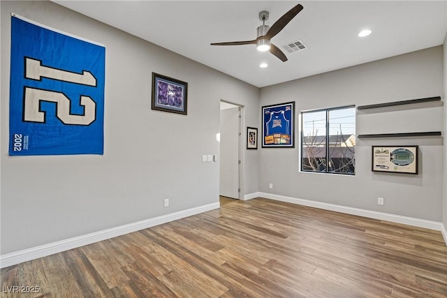 spare room featuring ceiling fan and hardwood / wood-style flooring