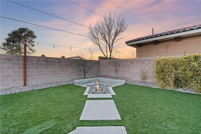 yard at dusk with a fire pit