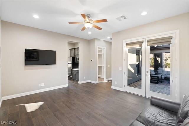 unfurnished living room featuring ceiling fan, dark hardwood / wood-style flooring, and french doors