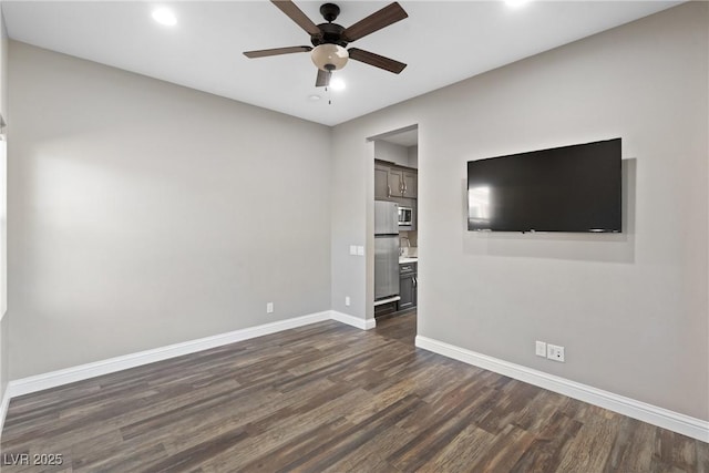 interior space with ceiling fan and dark hardwood / wood-style flooring