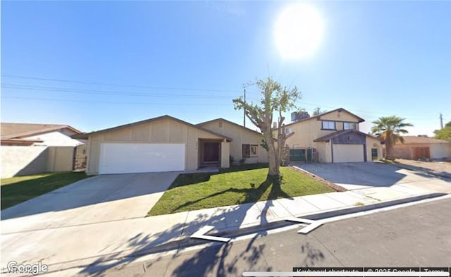 view of front of property featuring a front lawn and a garage