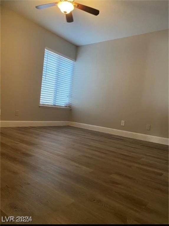 spare room featuring ceiling fan and dark hardwood / wood-style flooring