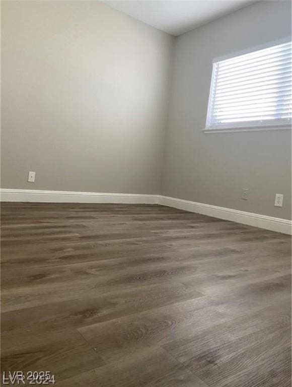 spare room with dark wood-type flooring