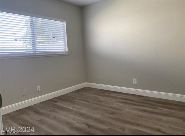 empty room featuring dark hardwood / wood-style flooring