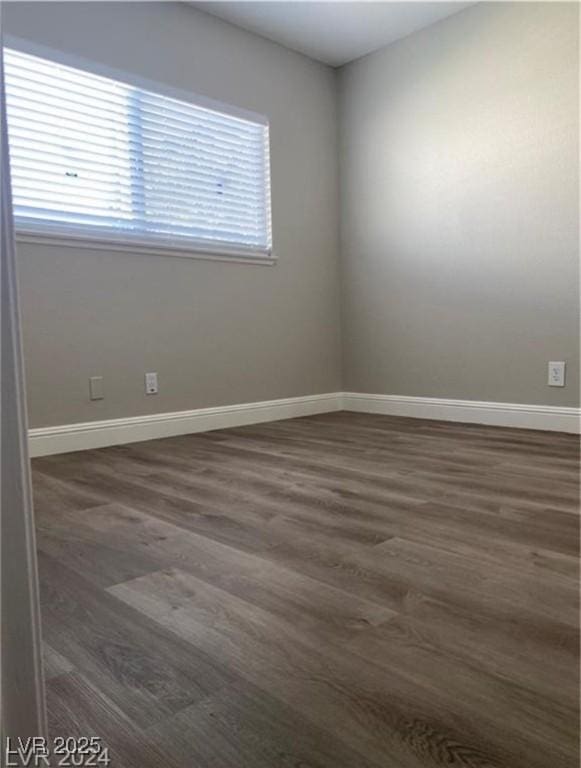 spare room with dark hardwood / wood-style floors