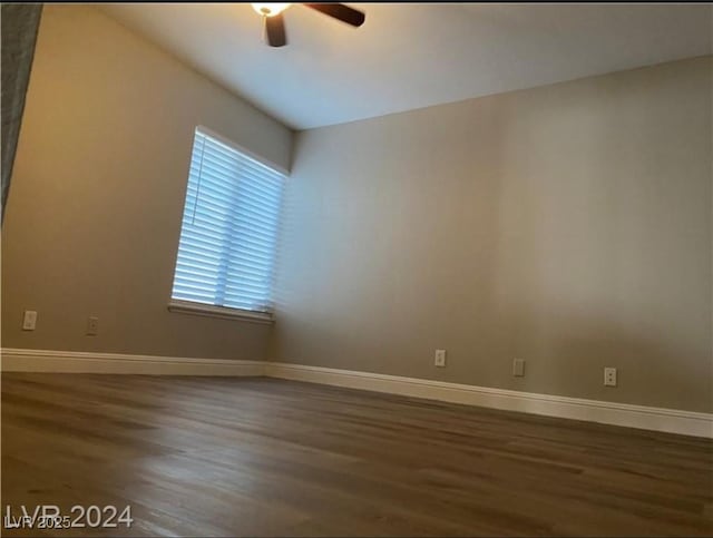 spare room with ceiling fan and dark hardwood / wood-style flooring