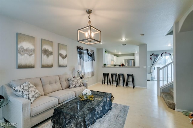 living room with a chandelier and light hardwood / wood-style flooring