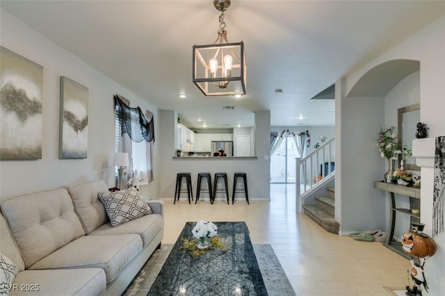 living room featuring an inviting chandelier and light hardwood / wood-style floors