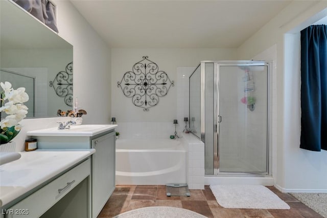 bathroom with vanity and independent shower and bath