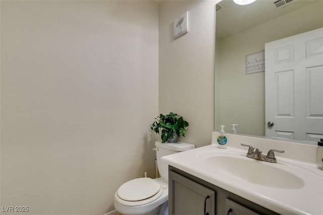 bathroom featuring toilet and vanity