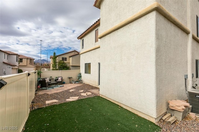 view of property exterior with central AC unit and a patio