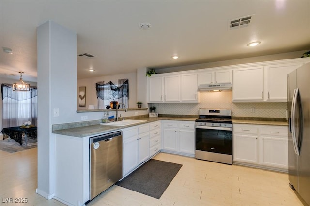 kitchen with sink, white cabinets, stainless steel appliances, and tasteful backsplash