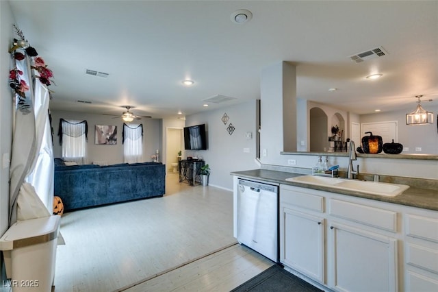 kitchen with ceiling fan, white cabinets, dishwasher, and sink