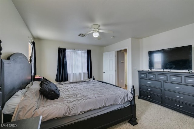 carpeted bedroom with ceiling fan and multiple windows