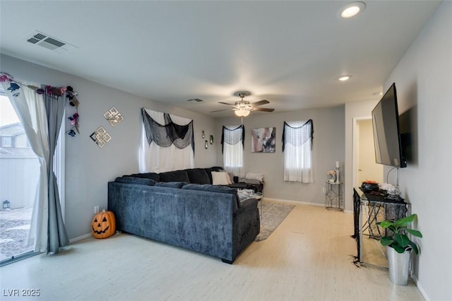 living room featuring ceiling fan and hardwood / wood-style flooring