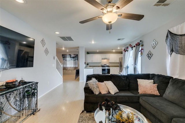 living room featuring ceiling fan and light wood-type flooring