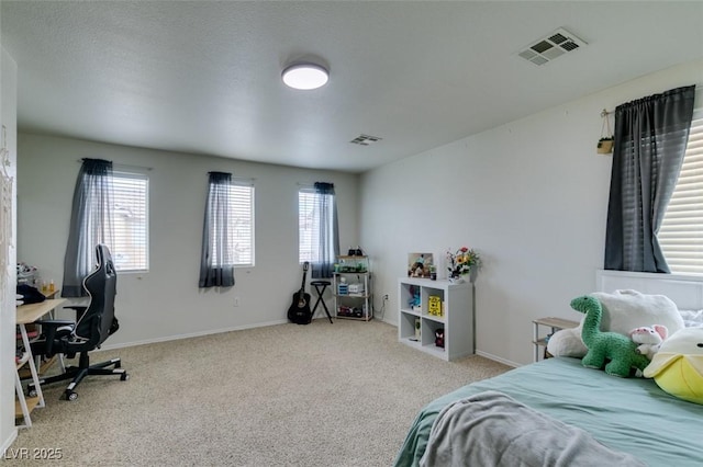 bedroom featuring multiple windows and light carpet