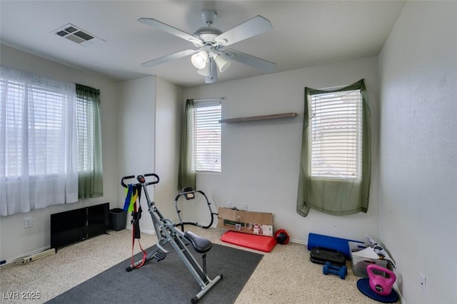 exercise area with ceiling fan and carpet floors