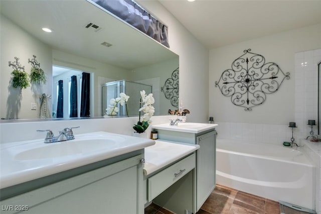 bathroom with vanity and separate shower and tub