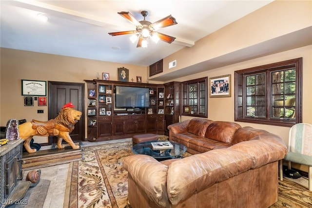 living room featuring ceiling fan and beam ceiling