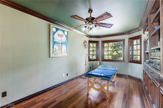 interior space with ceiling fan, dark wood-type flooring, and ornamental molding