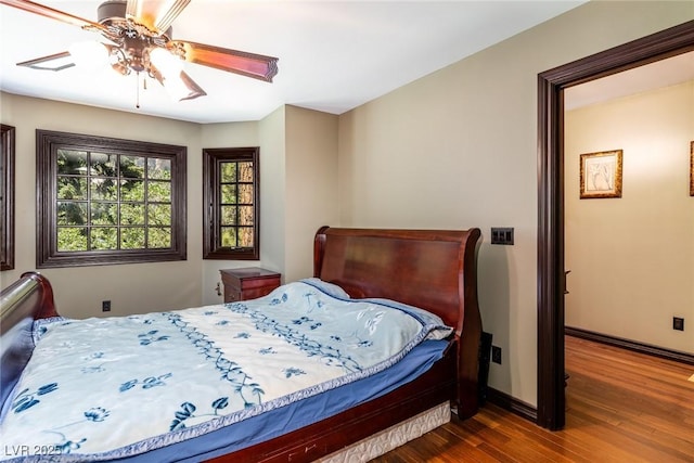 bedroom featuring dark wood-type flooring and ceiling fan