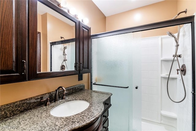 bathroom featuring an enclosed shower and vanity