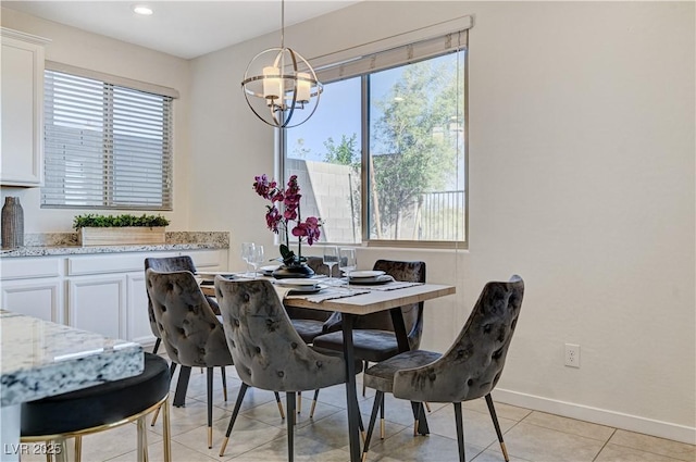 dining area with light tile patterned floors and a notable chandelier