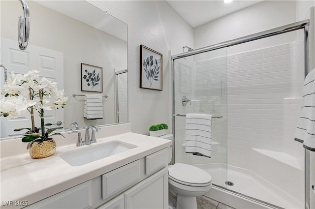 bathroom with toilet, a shower with door, and vanity